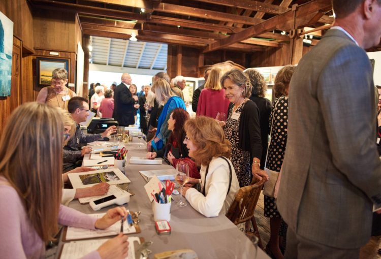 Art sales table with customers at MarinScapes 2019