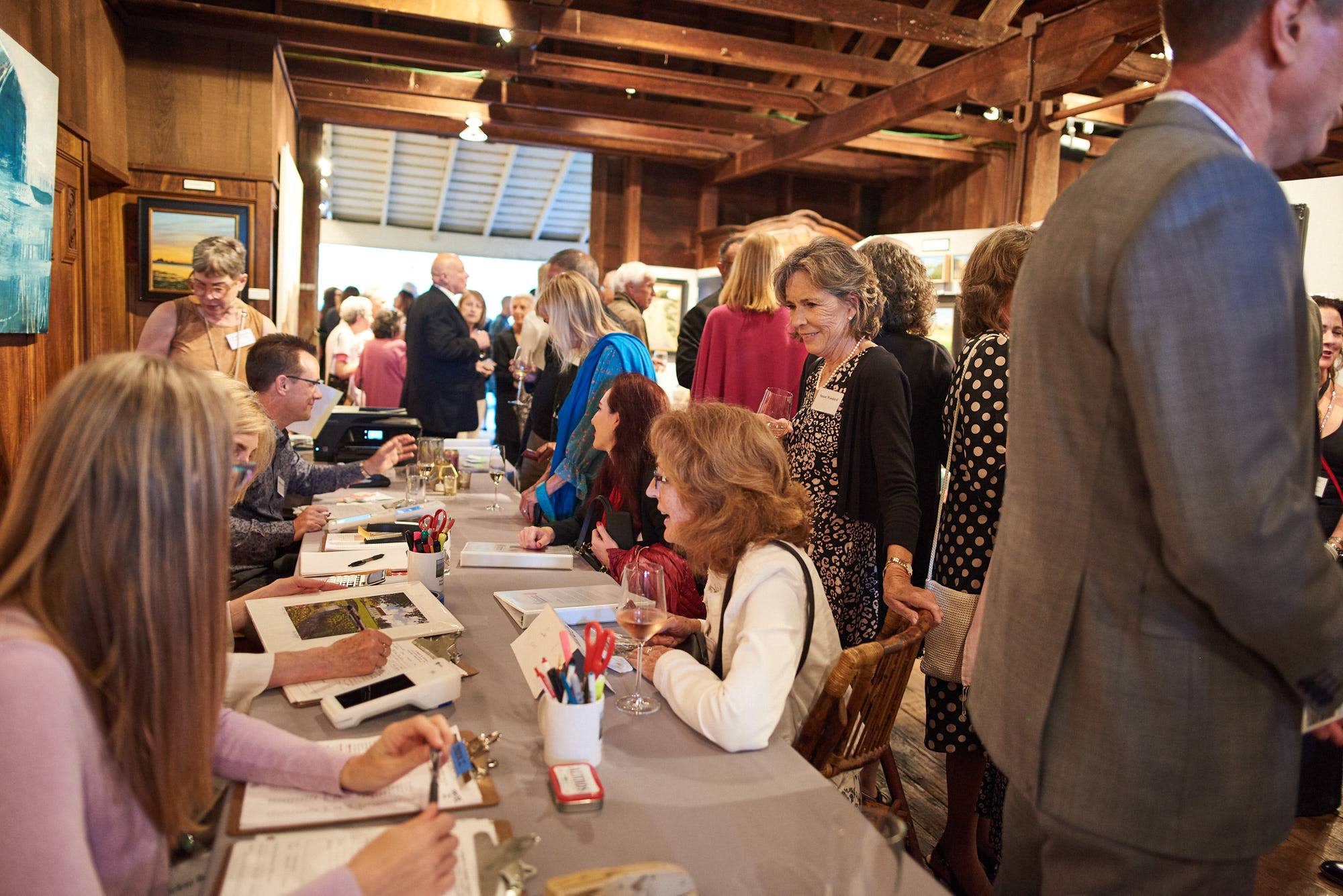 Art sales table with customers at MarinScapes 2019